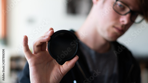 photography influencer holding a camera filter photo