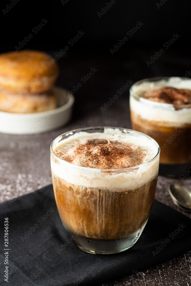 Affogato coffee with ice cream on a glass cup, dark, black background.