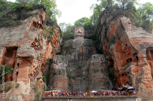 The Leshan Giant Buddha or Leshan Grand Buddha near Chengdu, Sichuan, China. The Leshan giant is the tallest stone Buddha statue in the world. View from a boat on the river near to Leshan and Chengdu. photo