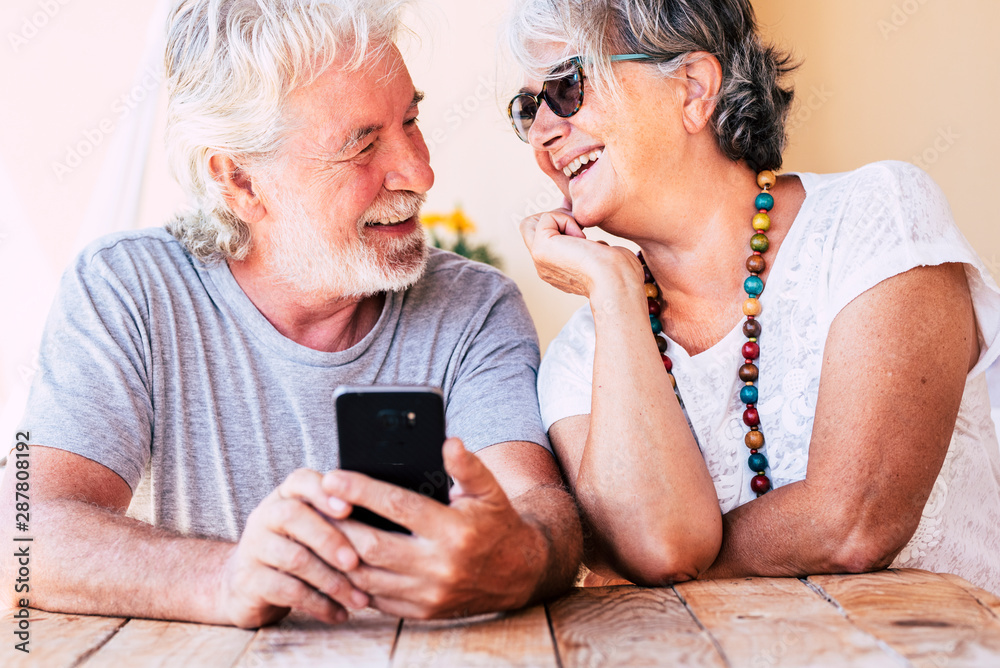 Couple of old happy cheerful people caucasian senior man and woman smiling together each other with love - concept of forever together life - joyful for aged family Couple of old happy cheerful people caucasian senior man and woman smiling together each other with love - concept of forever together life - joyful for aged family