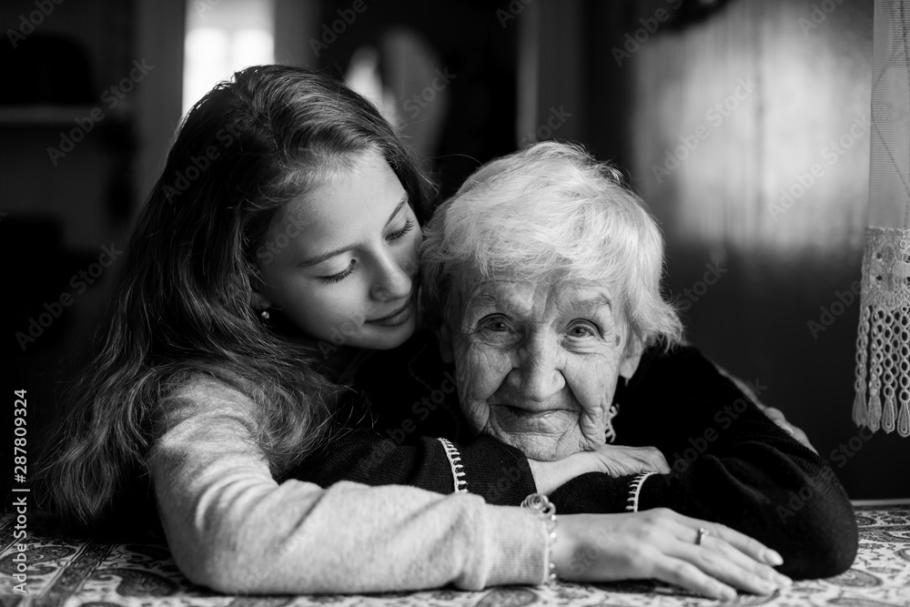 Φωτογραφία Portrait of an elderly gray-haired woman with her beloved granddaughter