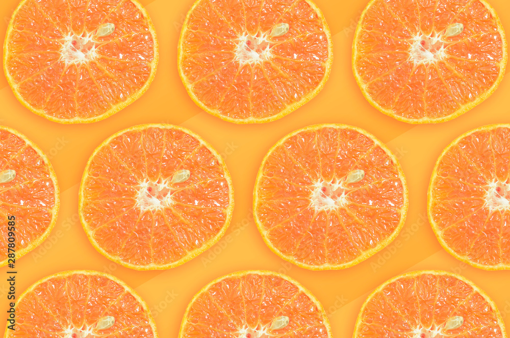 Sliced oranges pattern, fruit with one seed, orange tones on background. Sliced oranges pattern, fruit with one seed, orange tones on background.
