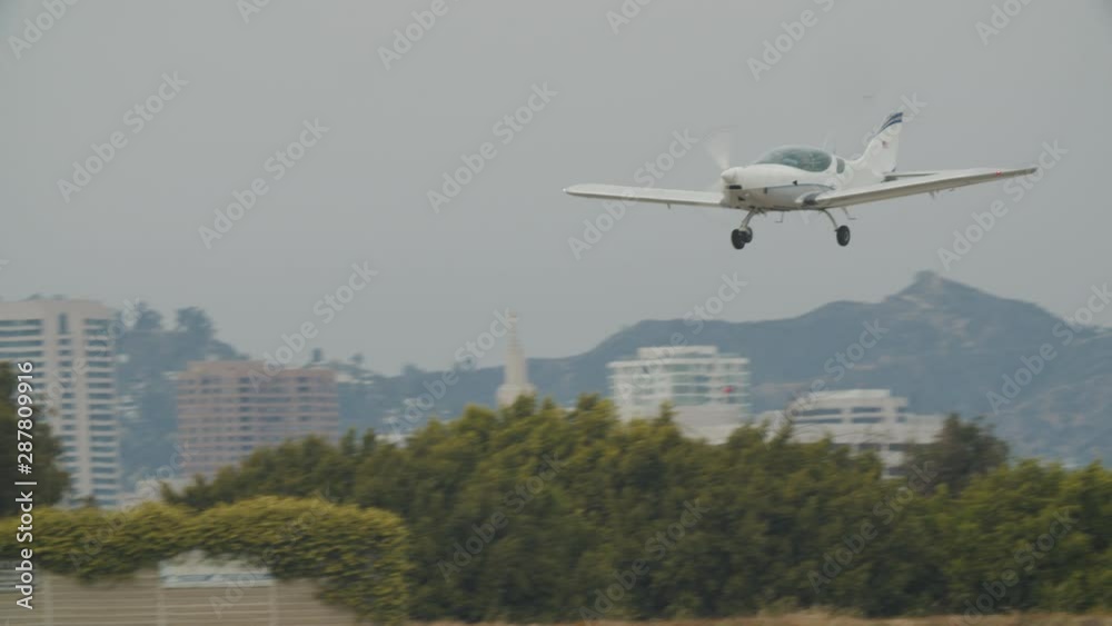 Small generic private propeller airplane preparing for landing, no tail or identification number. 60 FPS Slow Motion, 4K RAW graded footage