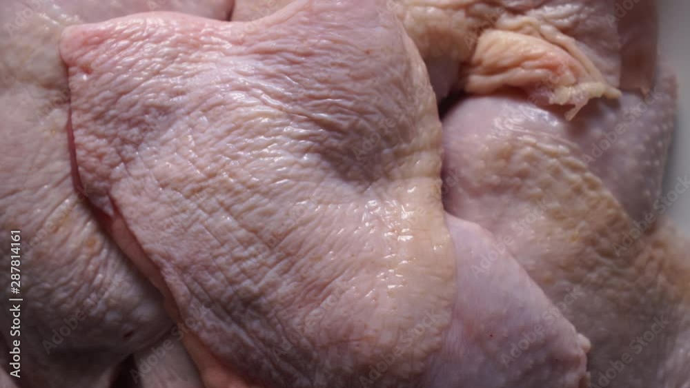 Raw boneless chicken legs in tray rotating in microwave defrosting top view. Raw boneless chicken legs in tray rotating in microwave defrosting top view.