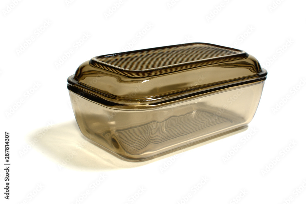 glassware of darkened glass for butter on white background glassware of darkened glass for butter on white background