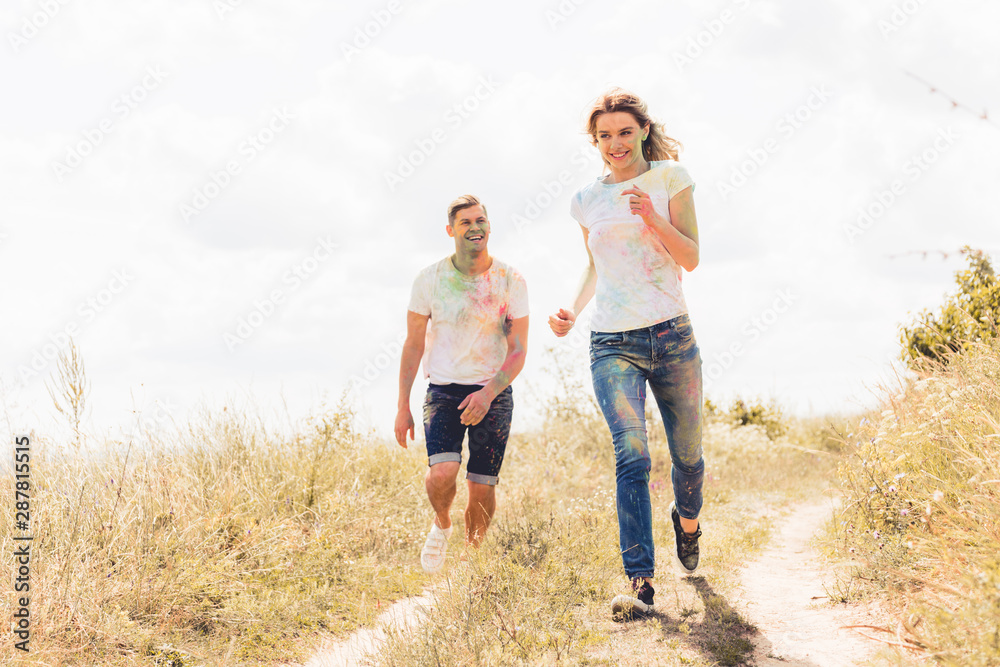 attractive woman and handsome man smiling and running outside attractive woman and handsome man smiling and running outside