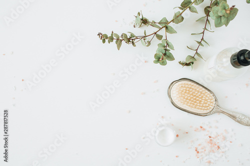 Healthcare spa concept with copy space mock up with eucalyptus, hairbrush, cream on white background. Flat lay, top view beauty lifestyle composition.