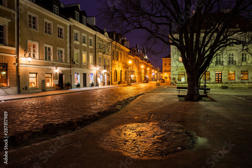 Houses along atmospheric Freta Street at New Town Square at night, Warsaw, Poland photo