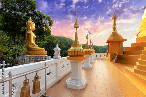 Golden Buddha statue and pagoda photo