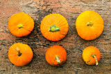 Orange autumn pumpkins flat lay on old wooden table