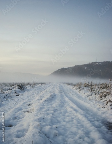 winter landscape with road and clouds