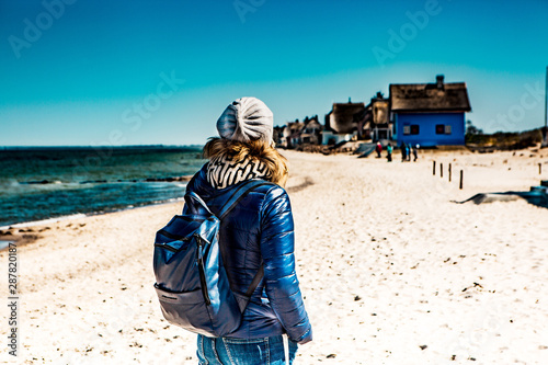 Woman baltic sea with houses on the beach photo