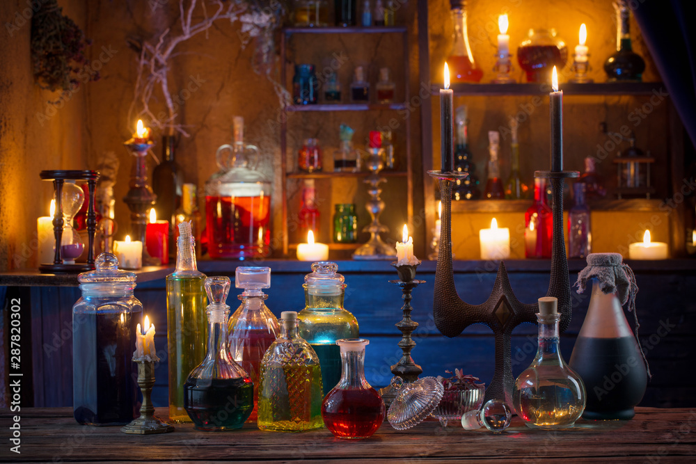 magic potions in bottles on wooden background - obrazy, fototapety, plakaty 