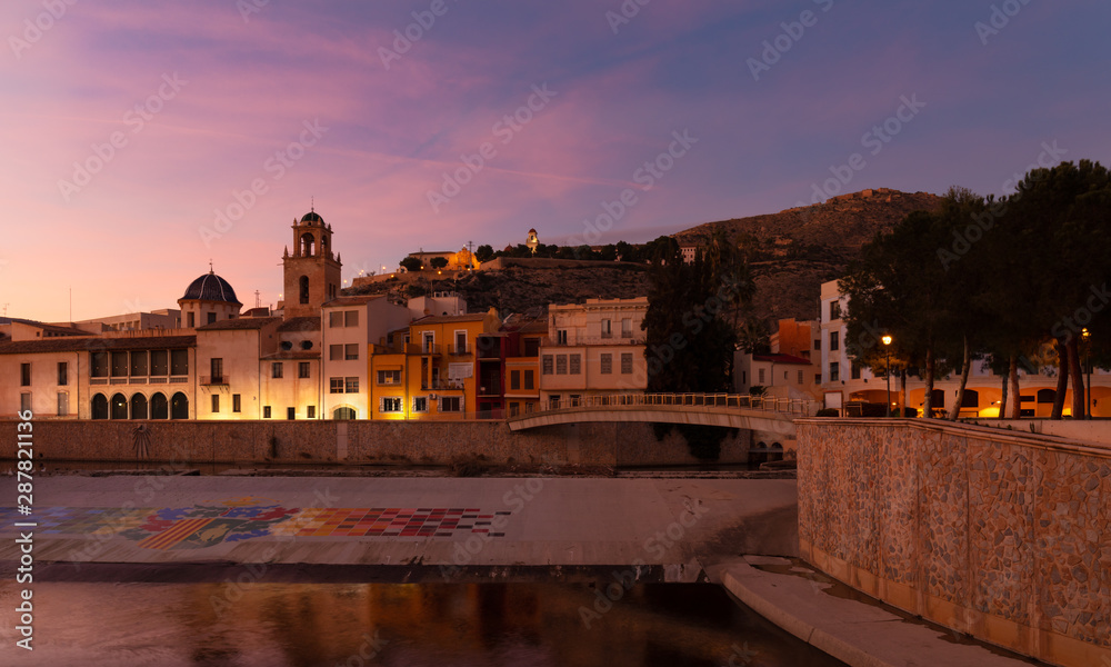 Evening mood in the southern Spanish city of Orihuela. On the mountain you can see the monastery, below a church and the river Segura, which flows through the city.