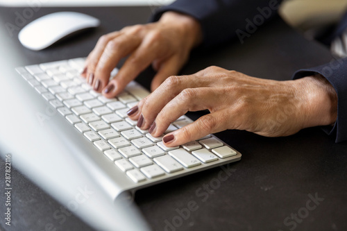 Woman's hands on computer keyboard, close-up