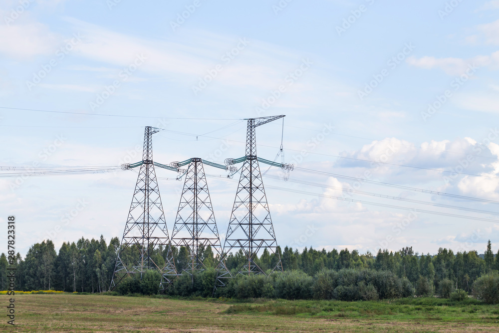 Group silhouette of transmission towers power tower, electricity pylon, steel lattice tower . Texture high voltage pillar, overhead power line.