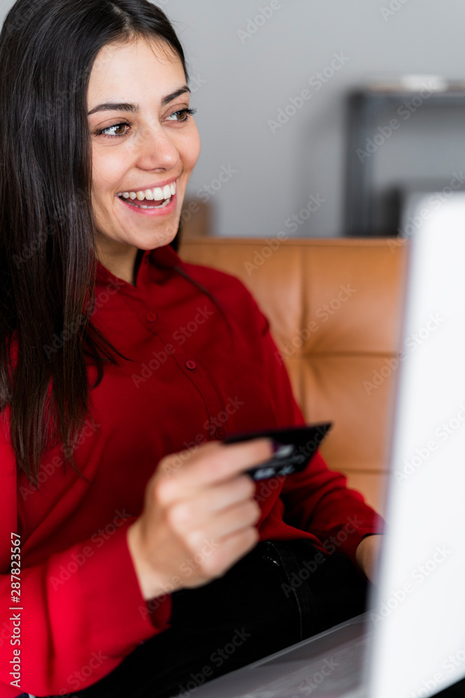 Happy young woman at home shopping online Happy young woman at home shopping online