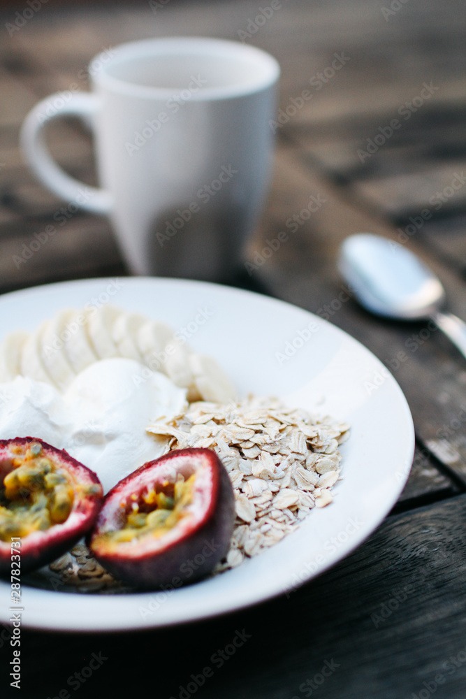 Breakfast detail with fruit and yoghurt on table Breakfast detail with fruit and yoghurt on table