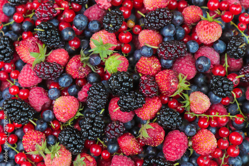 Fresh berries beautiful color background. Assorted berries blueberries strawberries mulberries red currants