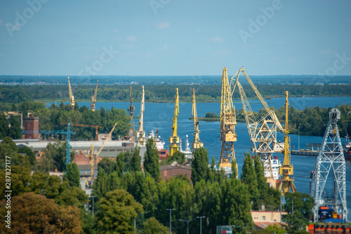 Cityscape with yellow cranes in the background