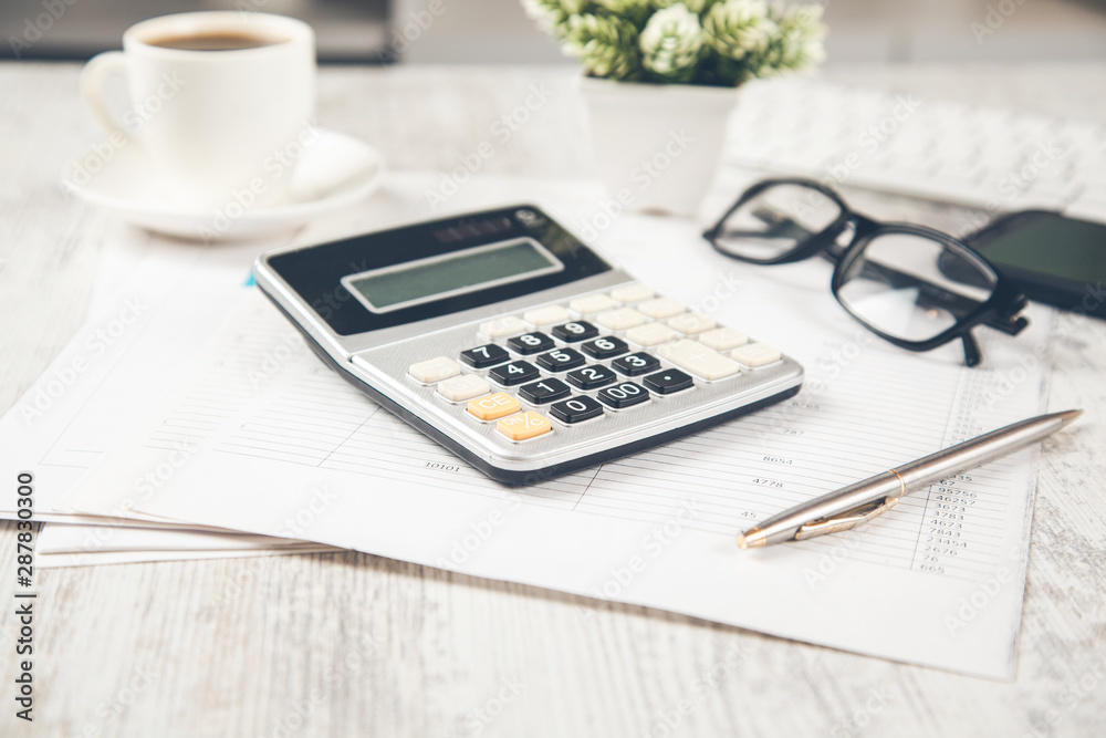 calculator on document and computer on desk calculator on document and computer on desk