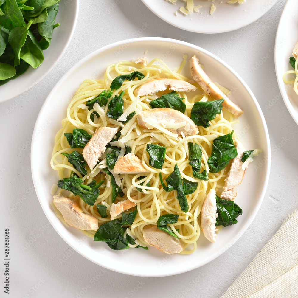 Spaghetti with spinach leaves, grilled chicken breast and cheese