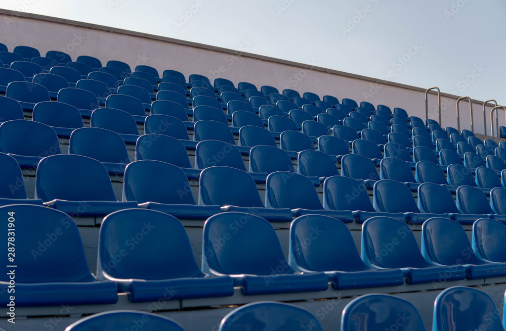 Fototapeta premium Bleachers in a sports stadium. Blue Seats In A Row