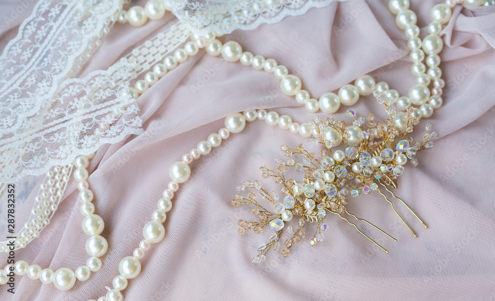 Wedding background with pearls and hair accessories on pink background Wedding background with pearls and hair accessories on pink background