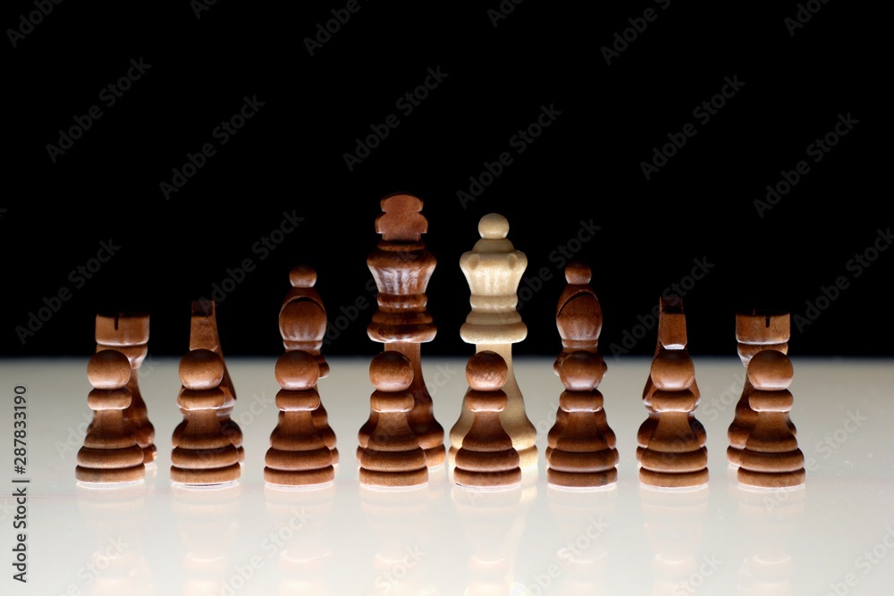 Black chess formation with a single white piece as a concept for undercover operations, infiltration, racial tension, ethnic minorities. Black chess formation with a single white piece as a concept for undercover operations, infiltration, racial tension, ethnic minorities.
