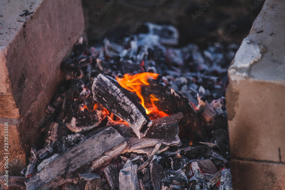 a small fire and nearby standing stones for skewers a small fire and nearby standing stones for skewers