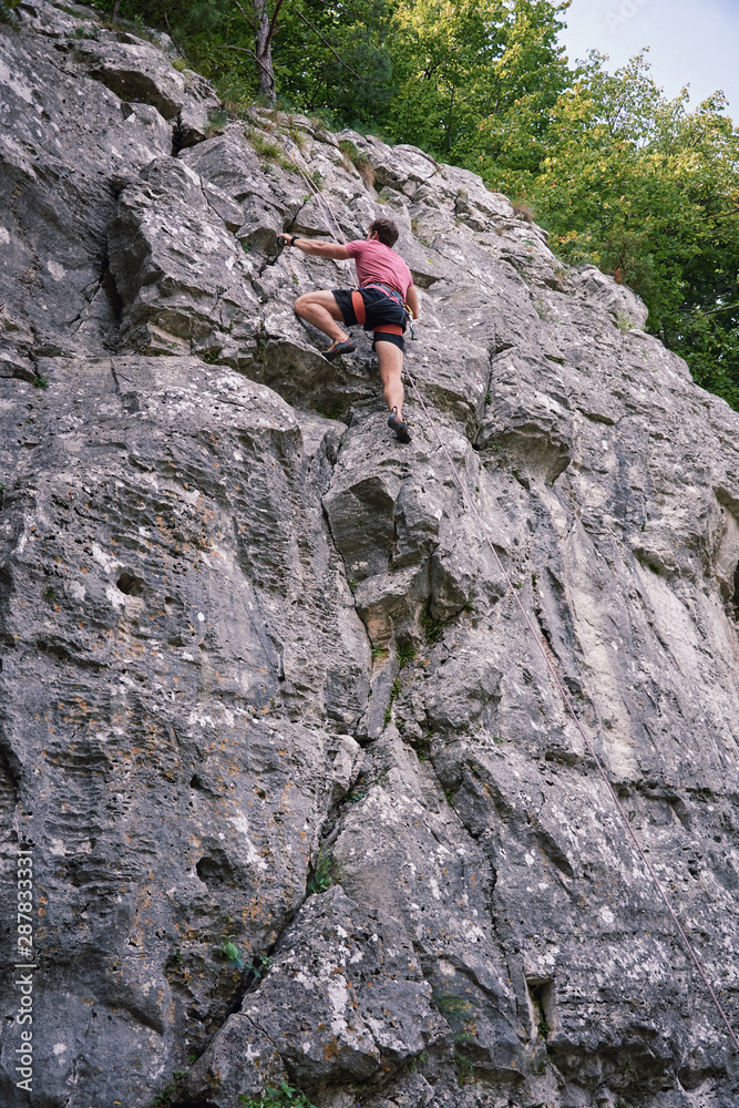 Young man rock sport climbing on Drevenik Slovakia