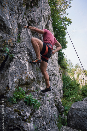 Young man rock sport climbing on Drevenik Slovakia