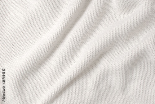 White, thick woollen sweater. Texture detail.