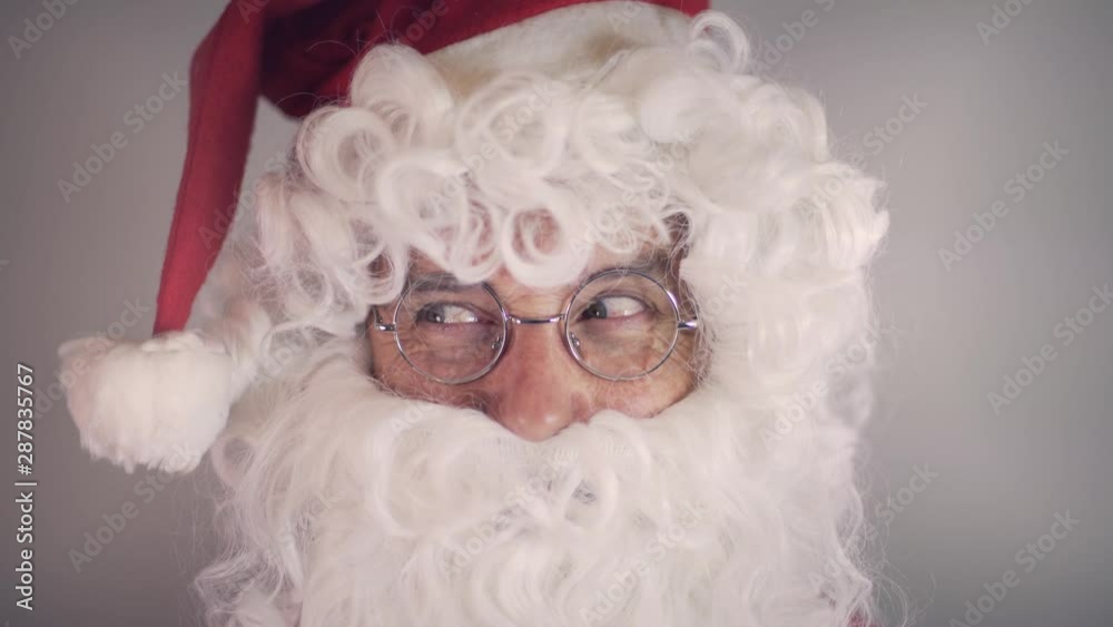Funny portrait of a man dressed in Santa Claus making funny faces and laughing, oh oh oh. Christmas time, holidays, vacations. Funny portrait of a man dressed in Santa Claus making funny faces and laughing, oh oh oh. Christmas time, holidays, vacations.