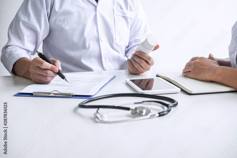 Doctor consulting with patient and checking sickness condition while presenting results diagnosis symptom examining about the problem of illness and recommend treatment method and using medicine Doctor consulting with patient and checking sickness condition while presenting results diagnosis symptom examining about the problem of illness and recommend treatment method and using medicine