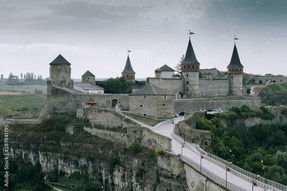 Castle in Kamianets-Podilskyi, Ukraine. Medieval stone large castle fortress with spiers and defensive towers