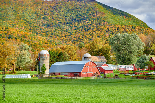 Farm with red barn and silos at sunny autumn day in West Arlington, Vermont, USA photo