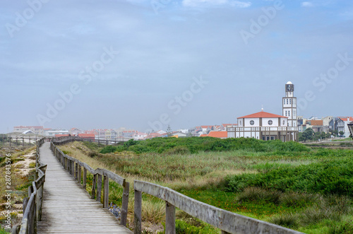 Wooden boardwalk path to the atlantic ocean beach in Costa Nova do prado, Portugal