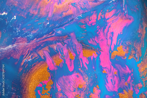 Abstract created using the technique of liquid acrylic. Macro photography of the smallest details of a picture. The picture shows how overflows of shades and colors of paint resemble space motifs.