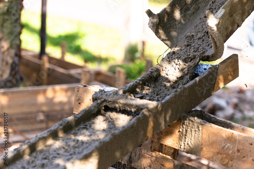 Wallpaper Mural Raking concrete. Concrete for parking lot construction. Thick concrete pouring down. Torontodigital.ca
