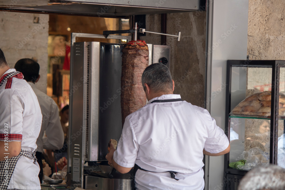 The chef who cuts doner kebab. Back of cook