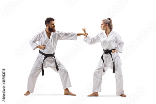 Male and female practicing karate