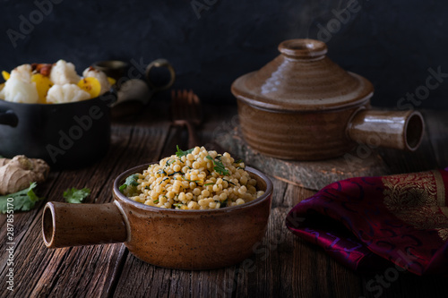 Middle Eastern Couscous and Steamed Vegetables in a Rustic Setting