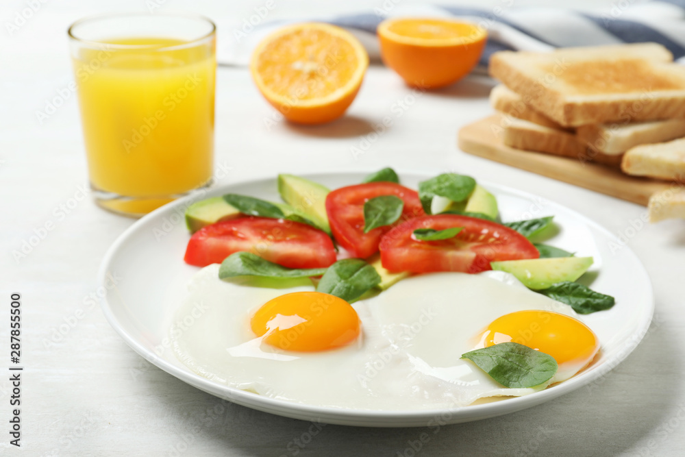 Delicious breakfast with fried eggs served on table, closeup
