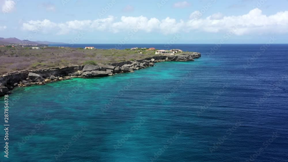 Aerial view of coast of Curaçao in the Caribbean Sea with turquoise water, cliff, beach and beautiful coral reef around Watamula Aerial view of coast of Curaçao in the Caribbean Sea with turquoise water, cliff, beach and beautiful coral reef around Watamula