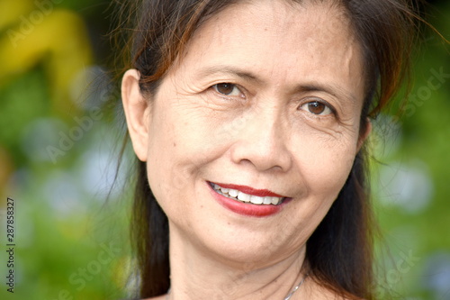 An Older Filipina Female Senior Smiling
