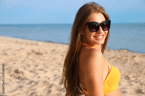 Beautiful young woman in bikini on beach