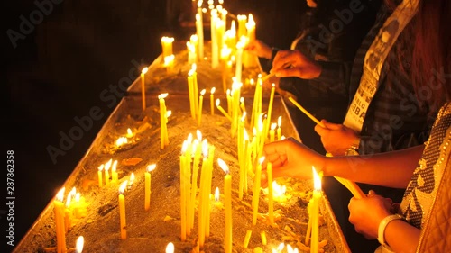 Woman Lights and Places a Candle in an Ancient and Authentic Christian Monastery, Armenia 1