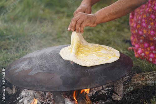 Cooking traditional Turkish borek, pide, pita or yufka bread photo