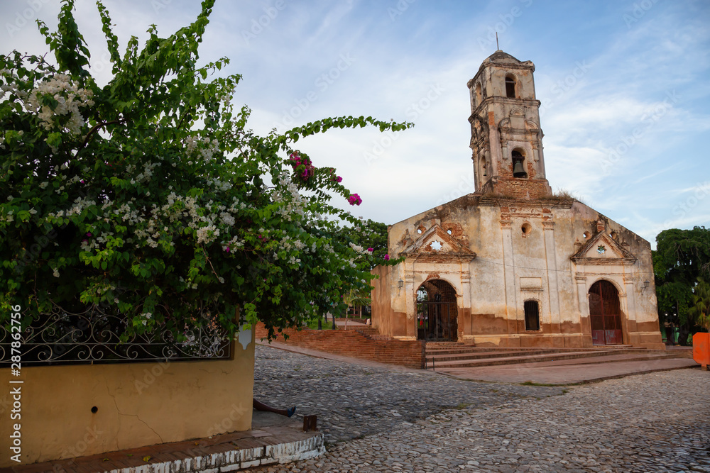 Beautiful View of a Church in a small touristic Cuban Town during a vibrant sunny and cloudy evening before sunset. Taken in Trinidad, Cuba.